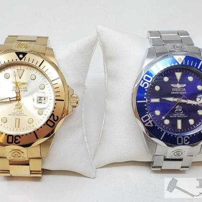 753	

Set of Two Grand Diver Invicta Watches
Includes gold Grand Diver Invicta watch, silver Grand Diver Invicta watch with blue accents
