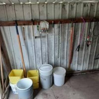 All buckets and garden tools on South side of shed