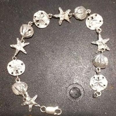 https://www.ebay.com/itm/124156078617	RX4152003 STERLING SILVER 925 7 INCH SEA SHELL, SAND DOLLAR, STAR FISH BRACELET  RX BOX 1 RX415203...