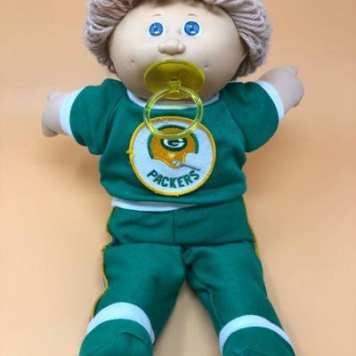 Boy Cabbage Patch doll w/pacifer wearing Green Bay Packers track suit