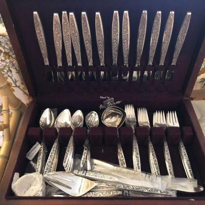 Sterling silver flatware in wooden chest.