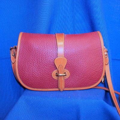 Lot 307: Red Dooney and Bourke Purse 10 x 6 1/2 x 2 1/2-small scuff marks on front strap; glue marks on interior suede  $25