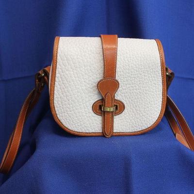 Lot 305: Dooney and Bourke Bag: white textured leather with brown leather accents 7 1/2