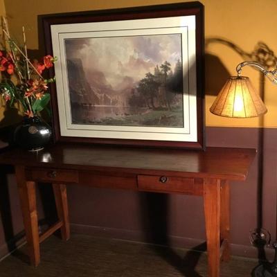 Teak Sofa/Library Table. 63in W x 18-3/4in D x 30in H. Faux Orchid, Antowue Floor Lamp and Framed Bierstadt print.