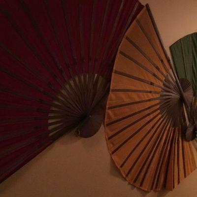 Trio of decorative wall fans.