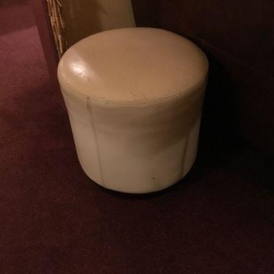 White Leather Ottoman (fair condition, some apparent wear) Diameter= 18-1/2 in. X H= 18-1/2.