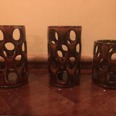 3 ceramic candle holders. There is a chip on the inside base of one candle holder.
