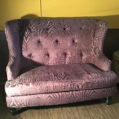 52vin. Wing back Love seat. Upholstered in a Lavender Damask Zebra print.
