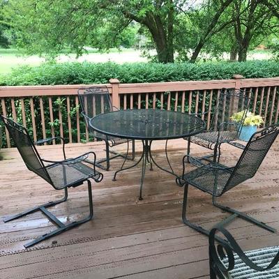 Wrought iron patio table with spring chairs

