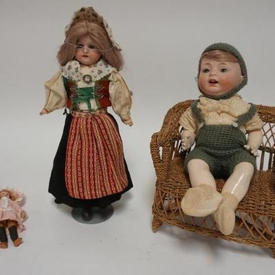 1065	GROUP OF THREE BISQUE HEAD DOLLS, ONE IS MINIATURE W/ A WOODEN BODY (5 IN H) A GIRL DOLL W STAND & A BOY DOLL W/ DOLL ARMCHAIR...