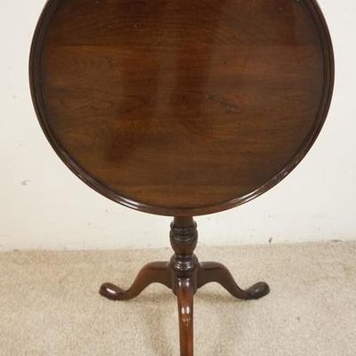1141	SNAKE FOOT TILT TOP CANDLE STAND. HAS A BURN MARK ON THE TOP. 21 1/2 IN DIAMETER, 26 1/2 IN HIGH
