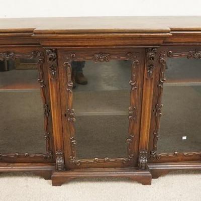1043	VICTORIAN CARVED 3 DOOR CREDENZA IN THE MANNER OF MEEKS HAS 3 GLASS DOORS & 2 SECRECT DOORS ON EITHER SIDES, 60 IN W, 35 IN H 
