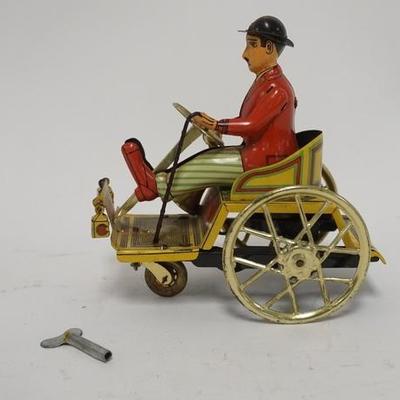 1298	TIN LITHO WIND UP TOY CAR & DRIVER, SIGNED HP 5 IN L, 5 1/2 IN H 
