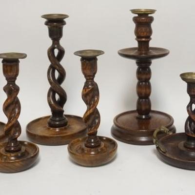 1069	 7 WOODEN CANDLESTICKS. 3 PAIRS AND A CHAMBER STICK WITH FIGURAL HANDLE. ALL HAVE BRASS BOBACHES, TALLEST IS 10 3/4 IN 
