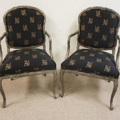 1022	PAIR OF BAKER CARVED SILVER GILT ARMCHAIRS W/ WINGED GRIFFIN UPHOLSTERY 
