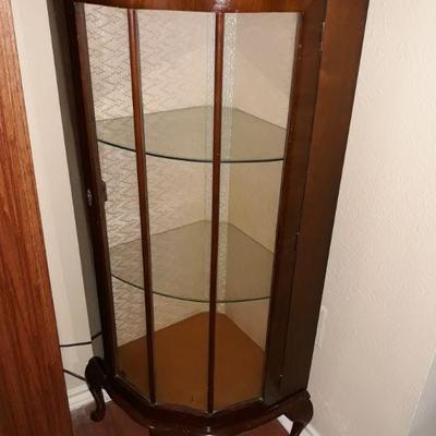 Nice corner display cabinet with curved glass and glass shelves. Excellent condition with key.