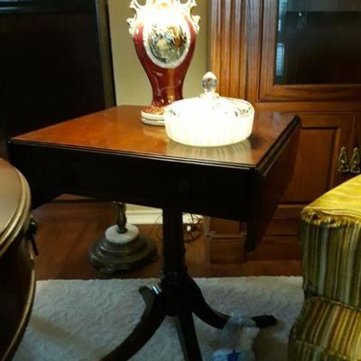 Matching Grand Rapids Certified Genuine Mahogany from Imperial with drop leaf ends and brass lion head pulls.