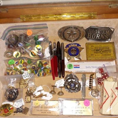 Collectible fountain pens, marbles, and medals.