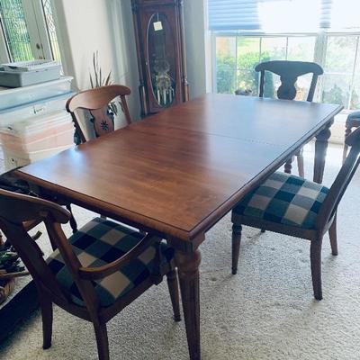 Contemporary dining table with six blue plaid chairs
