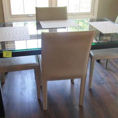 Lot 52 - Crate and Barrel Glass Kitchen/Dining Room Table W/ 5 chairs only 4 chairs pictured  steel base 60x36 $460.00