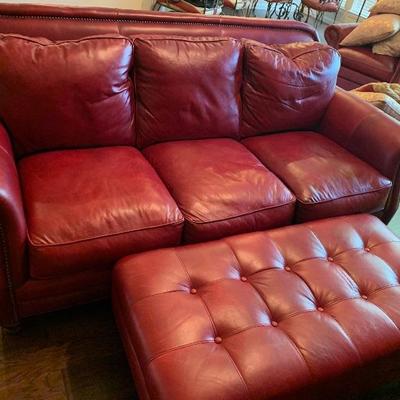 red leather couch with matching ottoman and recliners