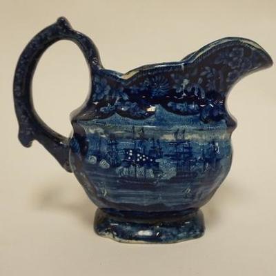1032	HISTORICAL BLUE CREAMER DEPICTING COMMODORE MCDONOUGHS VICTORY ON LAKE CHAMPLAIN 1814 BY ENOCH WOOD, HANDLE REPAIRED 5 1/2 IN H 
