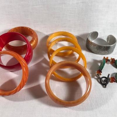 Bakelite bracelets:
small bangles $20 each
medium $24; orange larger $30; Red $30; carved $45
pewter cuff $22; green stone $10