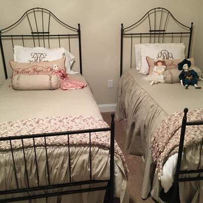 Pair of hand forged  wrought iron twin beds with mattresses and bedding. 