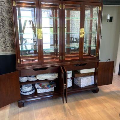 Drexel Heritage Ming Treasures collection china display cabinet with same carved design on lower doors. Interior lighting for glass...