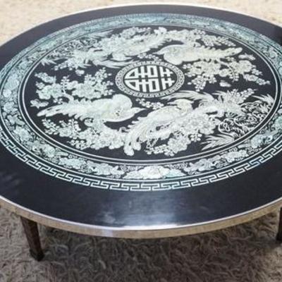 1022	BLACK LACQUER MOP INLAID ROUND COFFEE TABLE WITH FOLD UP LEGS. INLAY COVERED WITH CLEAR LACQUER.35 IN DIAMETER, 11 1/4 IN HIGH
