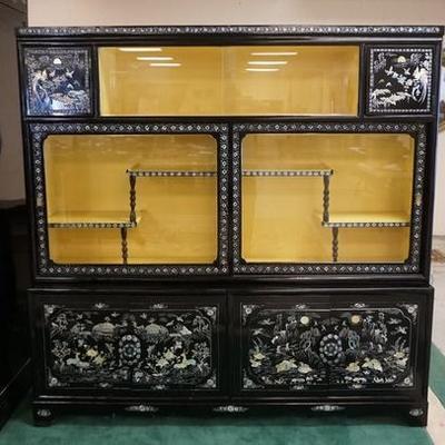 1015	LARGE BLACK LACQUER CABINET WITH INRICATE MOP INLAY. HAS 4 DOORS AND 2 SETS OF SLIDING GLASS DOORS. 2 INTERIOR SMALL DRAWERS IN THE...