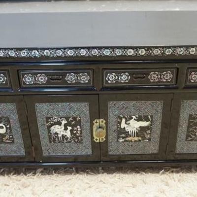 1018	BLACK LACQUER LOW CHEST WITH MOP INLAY OF BIRDS, ANIMALS AND FLOWERS. HAS DOORS AND DRAWERS. 39 1/2 IN WIDE, 19 IN HIGH
