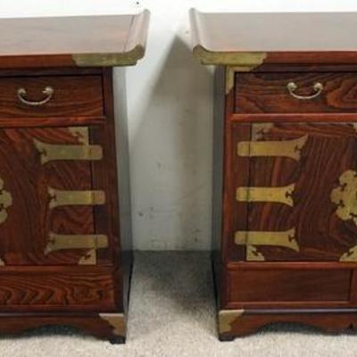 1059	PAIR OF KOREAN SMALL CABINETS WITH PAGODA TOPS AND BRASS TRIM. CALIGRAPHY ON THE BACKS, CONCEALED DRAWERS AT THE BASE. 25 IN WIDE...