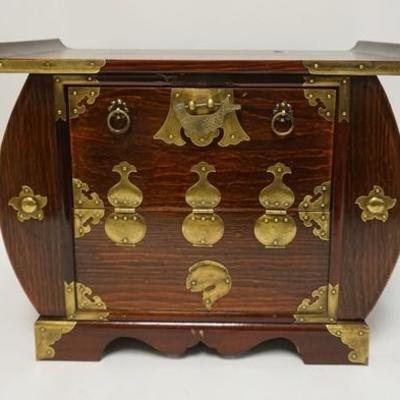 1049	ASIAN TABLETOP CABINET WITH BRASS TRIM. HAS CALLIGRAPHY IN THE INTERIOR. 20 IN WIDE X 12 IN DEEP X 15 1/4 IN HIGH
