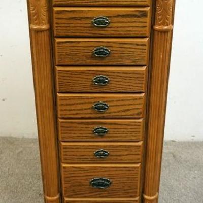 1086	OAK JEWELRY CABINET, HAS 9 DRAWERS, SIDE DOORS FOR NECKLACES AND A LIFT TOP WITH A MIRROR. 18 IN WIDE AND 42 1/2 IN HIGH.
