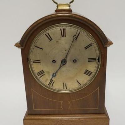 1003	ARCH TOP BRACKET CLOCK WITH CHIME. HAS KEY. 14 1/2 IN HIGH. FRONT GLASS DOOR MISSING, INLAID MAHOGANY CASE
