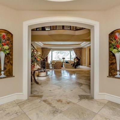 Entry View Entering Home Showing Tall White Blown Art Glass Trumpet Vases with Floral Arrangements.  (2 of 4 shown) 