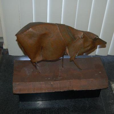 Metal pig on wood block