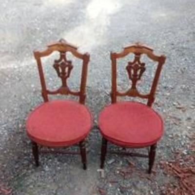 a pair of vintage side chairs with red cushions