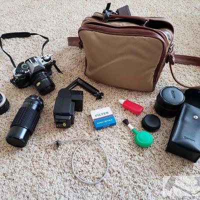 736	

Canon AE 1 Camera 3198116
Includes Cases, Lenses, Cleaning Tools, And More