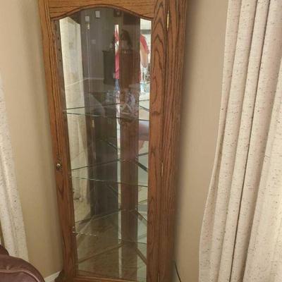 429	
Beautiful Curio Cabinet in Medium Finish by Sunny Designs
approximately 65 inches tall. One for the mirrors on the inside is cracked
