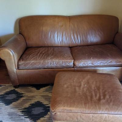 Leather 2 seat loveseat/sleeper sofa with leather ottoman $295