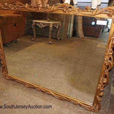 Lot: 710 - Semi antique highly carved and ornate gold gilt

Semi antique highly carved and ornate gold gilt style mirror with shell carving
