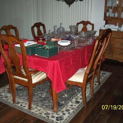 Dining Table with 6 Chairs and 1 Leaf, Area Rug, Crystal, and Boxed Christmas Ornaments.