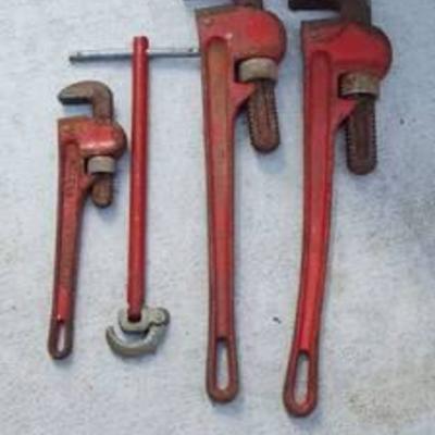 3 pipe wrenches, 10 inch and 2 - 18 in and basin wrench