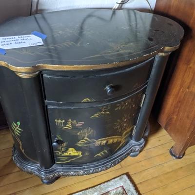 oval black lacquer handprinted Asian side table with 1 cabinet and 1 drawer
28