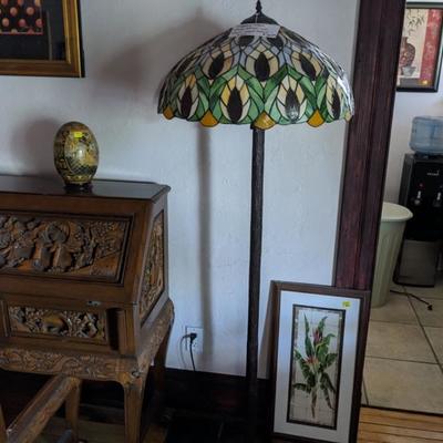 Tiffany style floor lamp metal faux wood pole and base. Some damage to glass shade. 
64