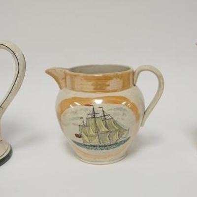 1010	THREE NAUTICAL THEME PITCHERS, BUFFALO POTTERY *MARINE JUG*, AND 2 UNMARKED PITCHERS W/SAILING SHIPS, TALLEST IS 9 IN
