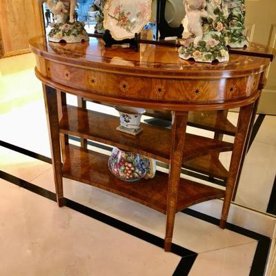 Federal style demi-lune table with tapered legs and marquetry inlay. 
 H30 3/4