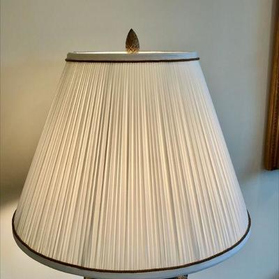 Black marble urn base table lamp with two attached semi-nude female angles, raised on a circular base. 
